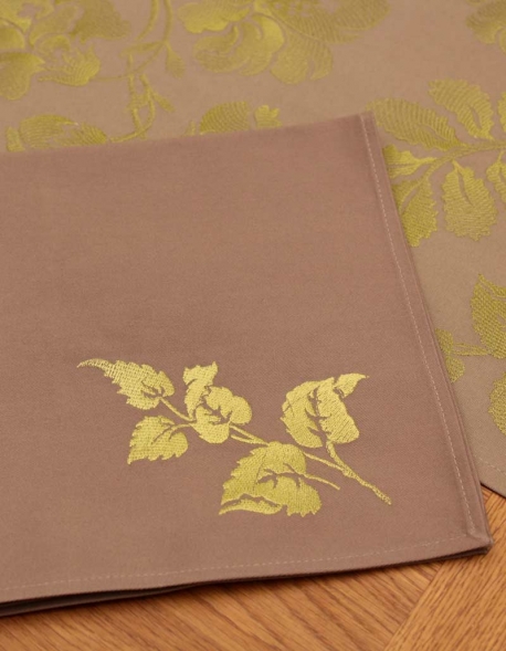 Napkin in pure cotton, dark beige color, embroidered with green leaves, made in France
